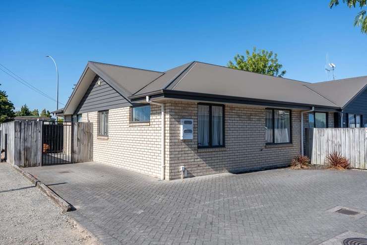 Zack Kendrick, pictured with partner Lily Davey, took over the keys for his first home in Hamilton East earlier this month. Photo / Supplied