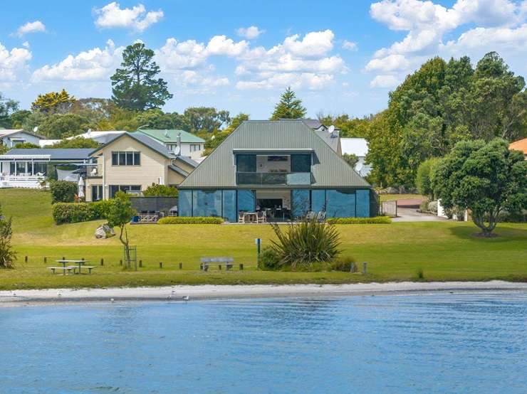 The distinctive waterfront house was designed by renowned Kiwi architect Ian Burrow and sold for just under $2m. Photo / Supplied