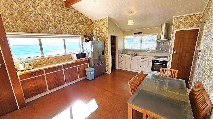 The three-bedroom, two-bathroom bach at 244 Kenwood Drive, in Matarangi, is one of first original beachfront properties. Photo / Supplied