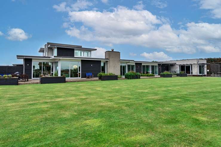 black and white house with clipped garden hedges 23 Tatham Road, Ti Point