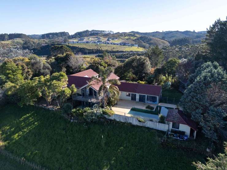 On the market for sale, with its three neighbours, is 240 West Hoe Heights, in Orewa. Earthworks for a housing development can be seen in the background. Photo / Supplied