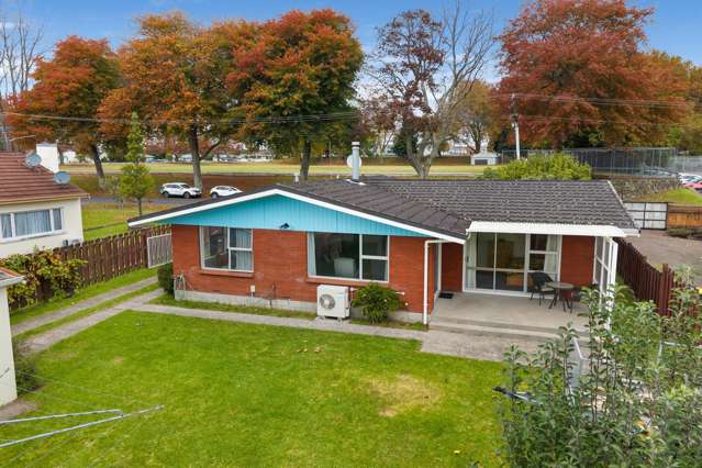Solid, sunny brick 1970's home on large section.