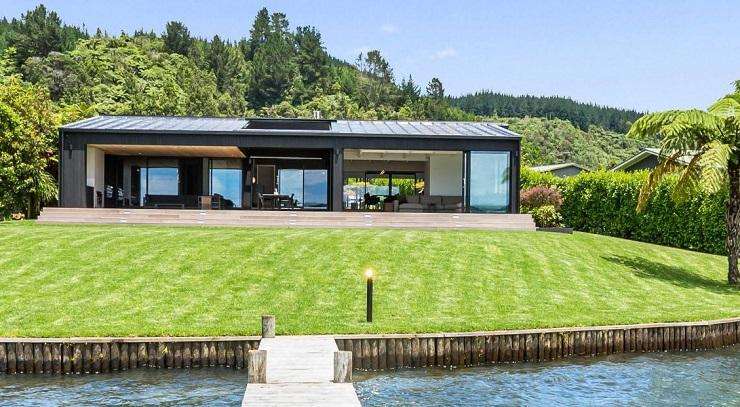 cedar house with lights and decks in foreground 257A Whangamoa Drive, Lake Rotoiti, Rotorua