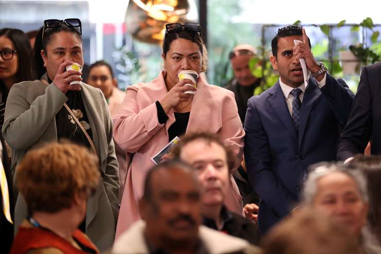 First-home buyers Sarah and Hayden Kingi in the thick of it at Ray White Manukau’s mega-auction on Wednesday. Photo / Fiona Goodall