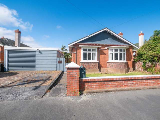 Spacious Three-Bedroom Brick Home with Garage and Fenced Backyard - Available Now!