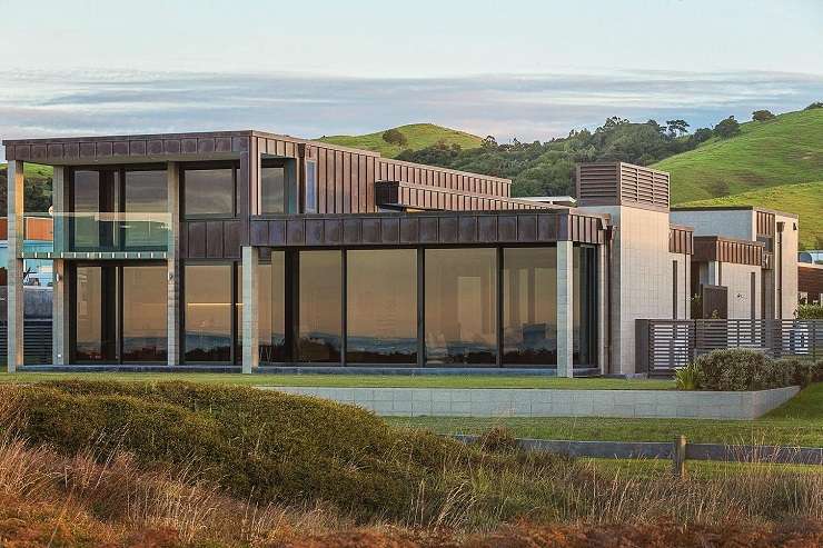 Modern cedar cube house with palm tree sand dunes sea  6 Kutai Lane, Omaha, Auckland