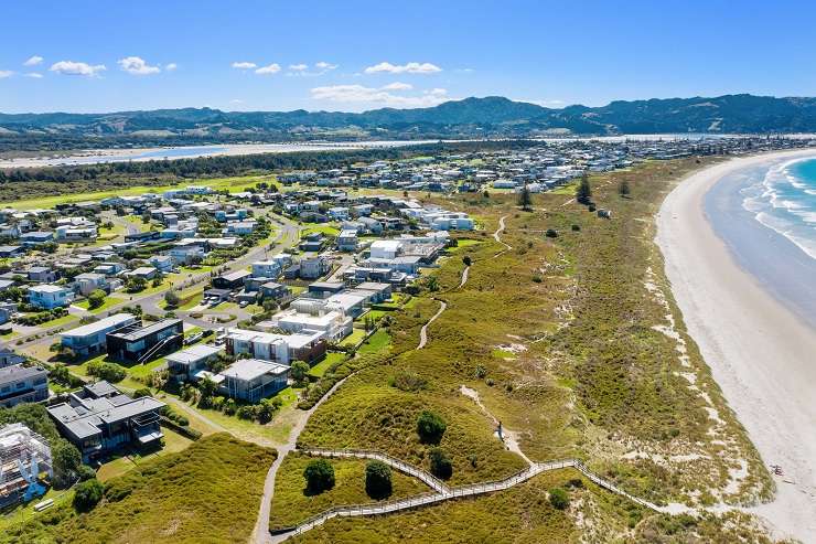 Modern cedar cube house with palm tree sand dunes sea  6 Kutai Lane, Omaha, Auckland