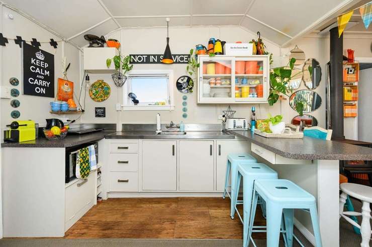 The 1950s three-bedroom bach at 15A Hall Place, in Foxton Beach, is packed with memories and treasures. Photo / Supplied