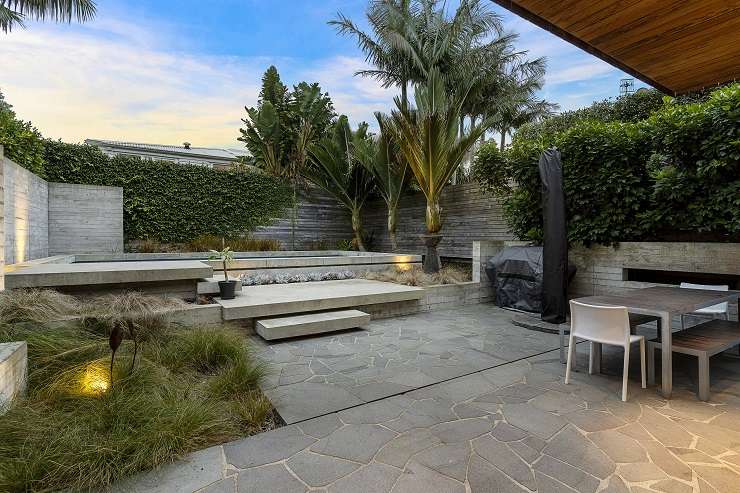 A three-bedroom house for sale on Regina Street, in Coxs Bay. The home, by architect Steven Lloyd, features concrete, glass and steel cantilevered over the carport. Photo / Supplied