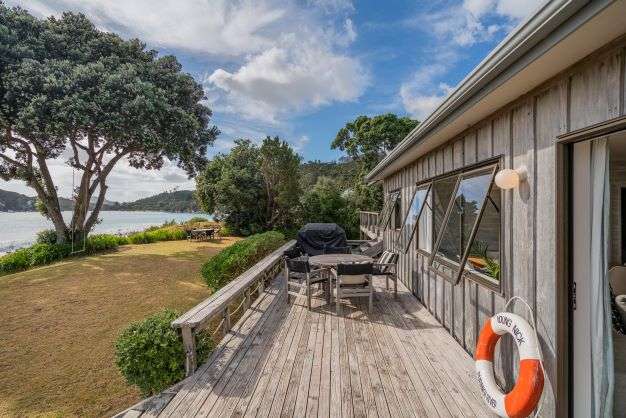 two chairs and bean bags on lawn of 8 Bay View Place in Ferry Landing, Thames-Coromandel