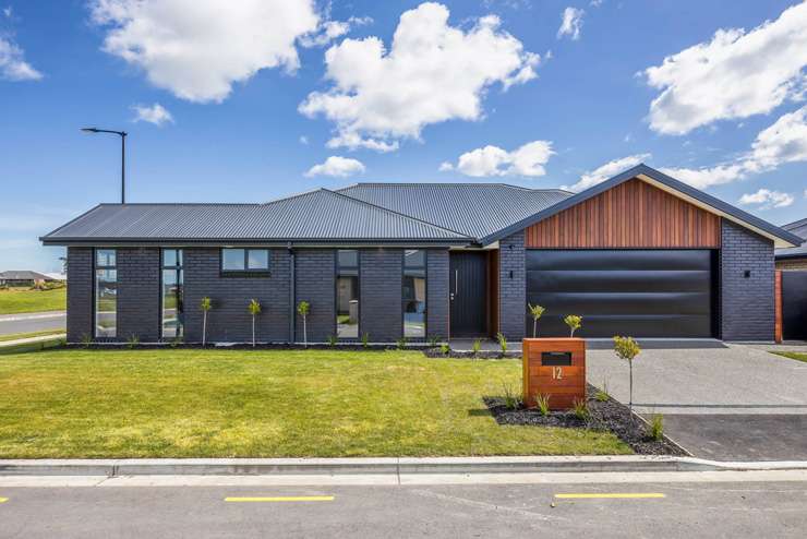 Bye bye New Zealand: The vendors of 42 Lockheed Street, in Hobsonville, Auckland, are off to Australia. Photo / Supplied