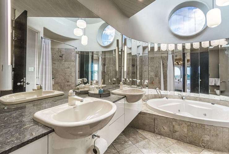 The distinctive waterfront house was designed by renowned Kiwi architect Ian Burrow and sold for just under $2m. Photo / Supplied