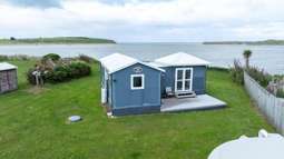 Tiny South Island bach heading to auction with $100,000 RV