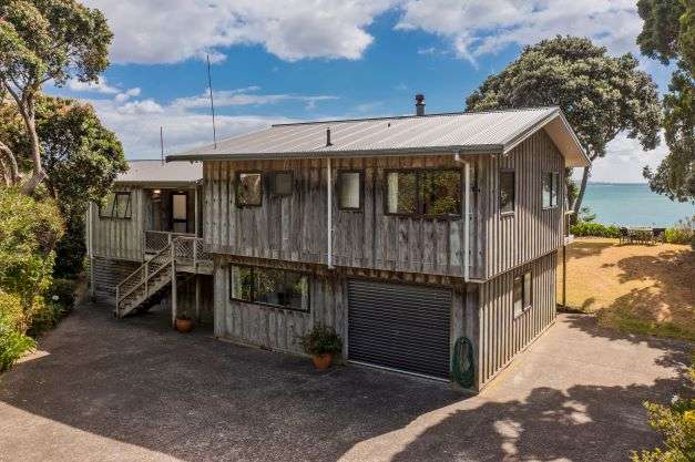 two chairs and bean bags on lawn of 8 Bay View Place in Ferry Landing, Thames-Coromandel