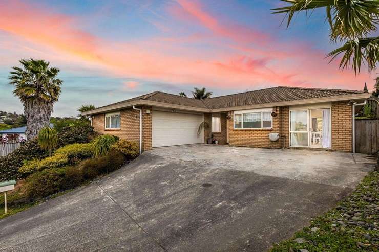 Cars lined the street outside 29 Puriri Road at last weekend's special open home for the property. Photo / Supplied