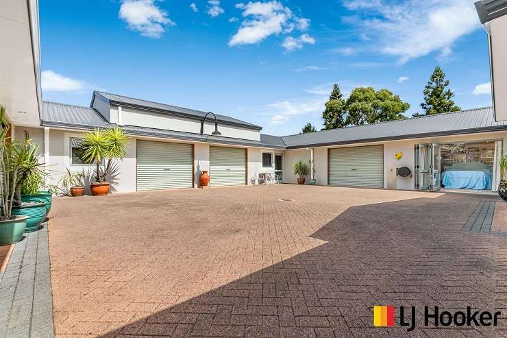 The four-bedroom, two-bathroom home at Church Road, in Ardmore, with extensive garaging is inviting interest from $2m plus. Photo / Supplied