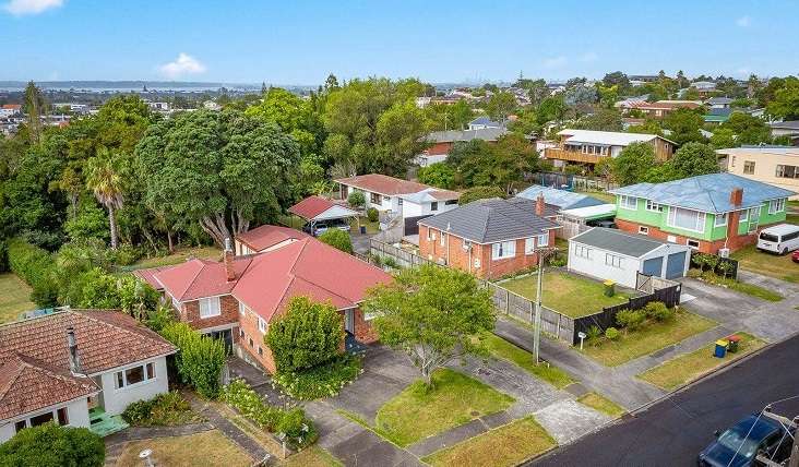 Aerial view of suburban house on winding road.