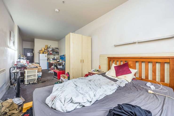 A three-bedroom, one-bathroom apartment in Grand Central, in Central Auckland, is to be sold at a <img reserve auction on Thursday. Photo / Supplied