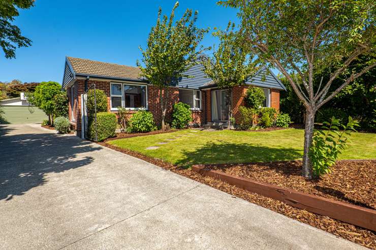 Keeva Irving and Nathan Lewis outside the Christchurch home they sold at auction for $850,000. Photo / Supplied