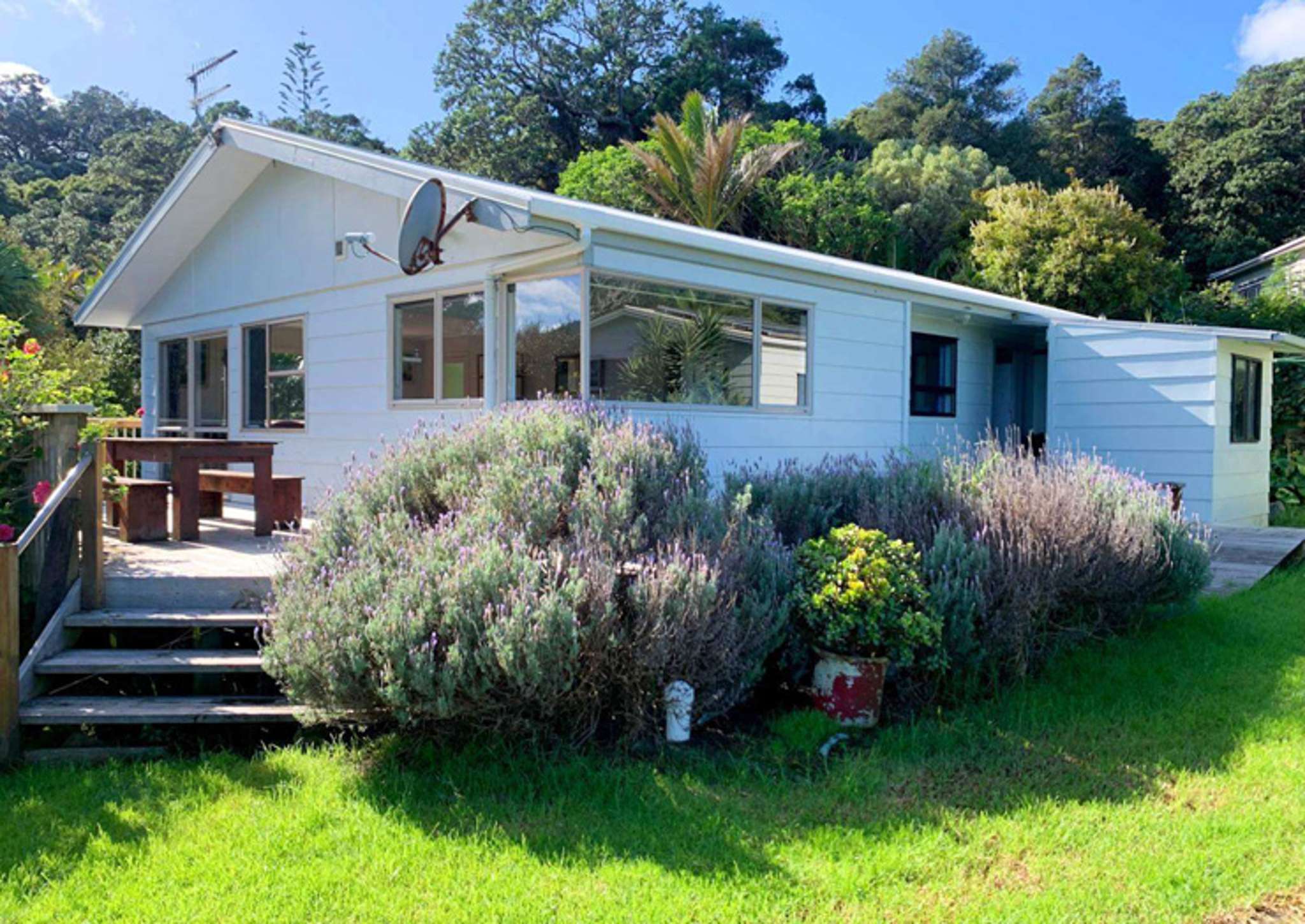 ‘Bid, bid, bid’: Great Barrier Island bach sells for $1.5m – more than double its CV