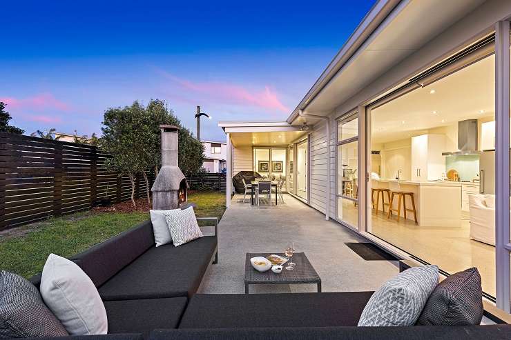 modern house and decking overlooking lawn and water  251 Omaha Drive, Omaha, Auckland