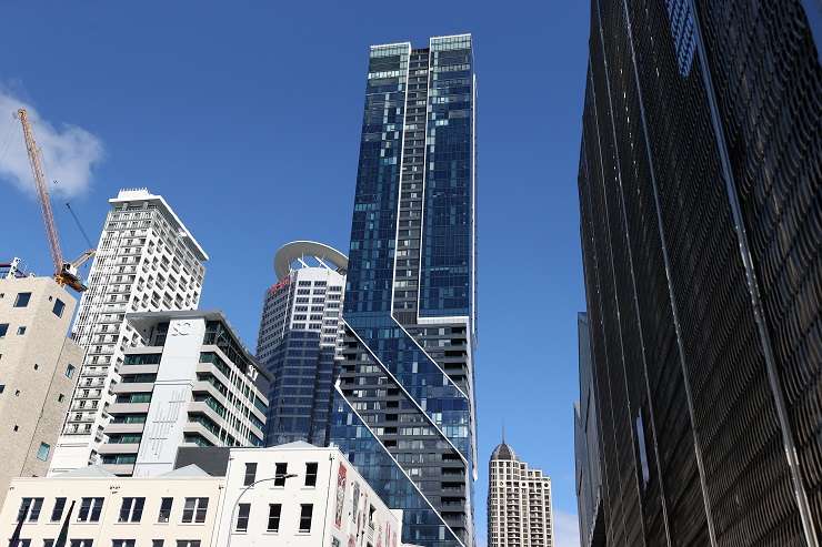 blue glass apartment tower wrapped with steel skeleton  Seascape apartment tower, 83 Customs Street, Auckland central