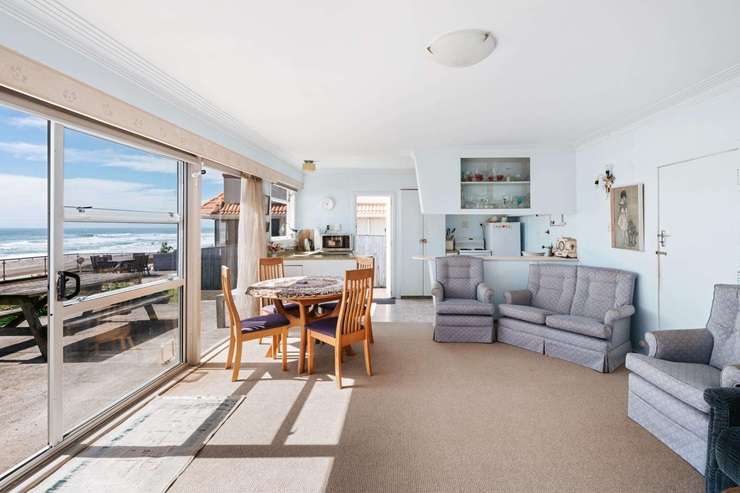 Listing agent Kay Ganley's mum Judy and her granddaughter Georgia appear in the marketing video for the 1950s beachfront bach on Oceanbeach Road, in Mount Maunganui. Photo / Supplied