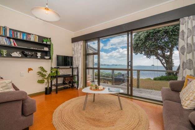 two chairs and bean bags on lawn of 8 Bay View Place in Ferry Landing, Thames-Coromandel