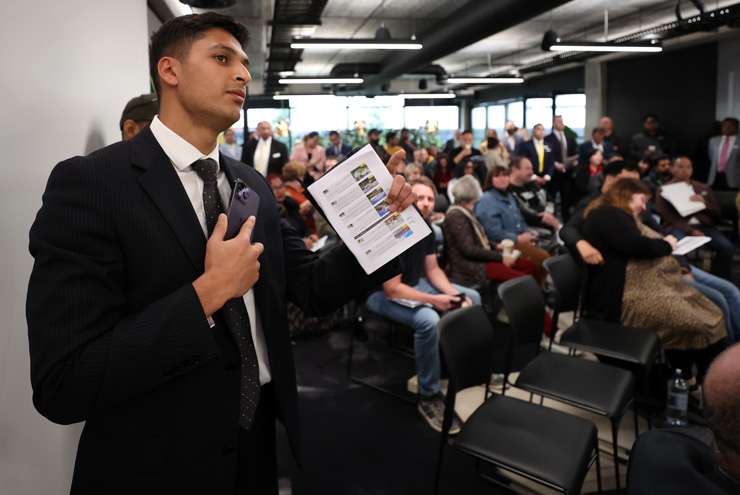 First-home buyers Sarah and Hayden Kingi in the thick of it at Ray White Manukau’s mega-auction on Wednesday. Photo / Fiona Goodall