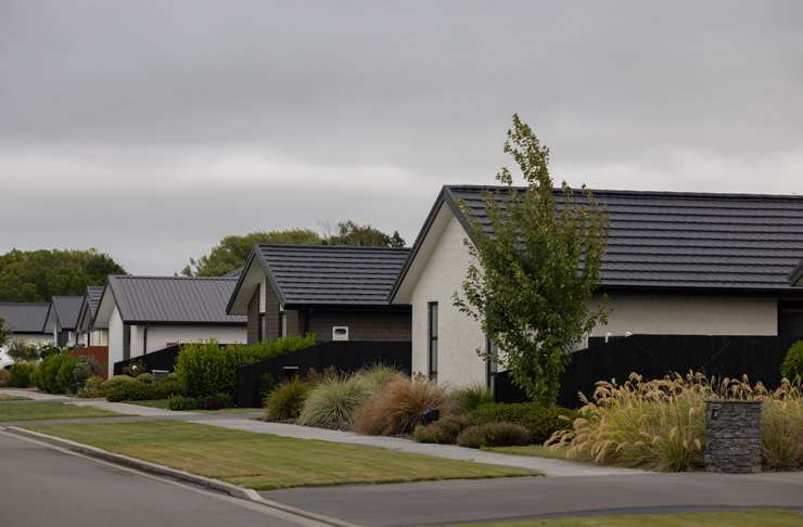 Bradyn Taylor, 21, and Emily Walker, 19, outside their new three-bedroom home in Rolleston, Canterbury. Photo / Supplied