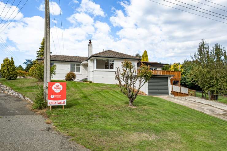 A three-bedroom home partially built from an old train carriage is on the market at 4 Driver Street, in Long Beach, Dunedin. Photo / Supplied