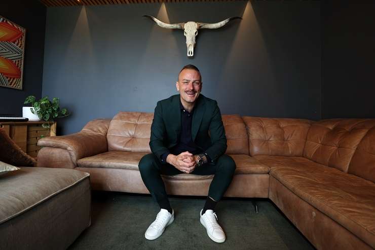 Barfoot & Thompson agent Paul Neshausen is wearing a Dolce & Gabbana sequin suit, a Versace shirt and Gucci shoes. Photo / Fiona Goodall