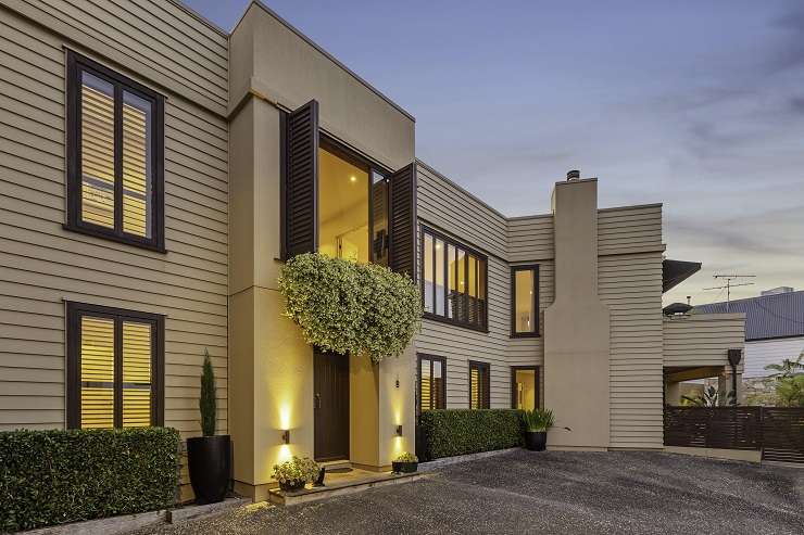 a white bungalow with hedge and lawn on 19 Platina Street, Remuera, Auckland