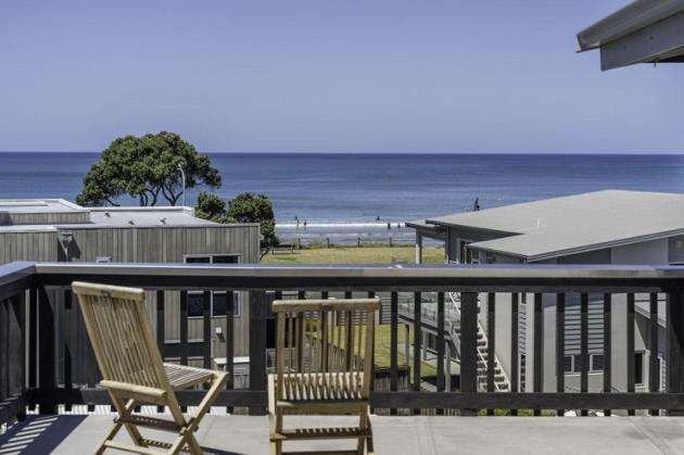 deck chairs overlooking roof tops to the sea at 306B Beverly Terrace, Whangamata, Coromandel Peninsula, Waikato