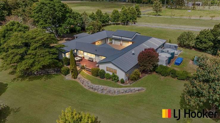 The four-bedroom, two-bathroom home at Church Road, in Ardmore, with extensive garaging is inviting interest from $2m plus. Photo / Supplied