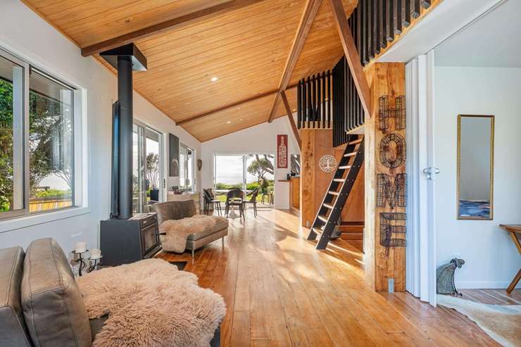 A cute two-bedroom beachfront bach at 122 Mangakahia Drive, in Whangapoua, is looking for a buyer with more than $3.2m to spend. Photo / Supplied