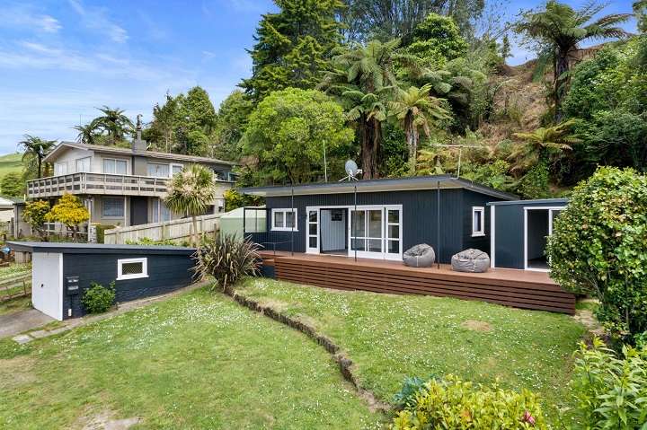 cedar house with lights and decks in foreground 257A Whangamoa Drive, Lake Rotoiti, Rotorua