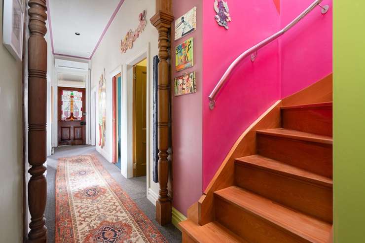 The villa for sale at 62 Pirie Street, in Mount Victoria, Wellington, has a distinctive colour scheme. The window frames and door are painted pink. Photo / Supplied