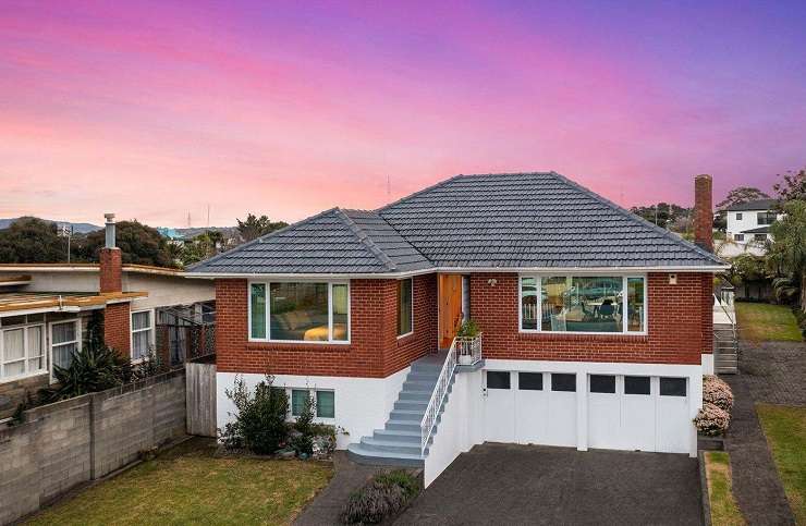 brick house with sunset sky and reflecting pool in front 444 Old Te Atatu Road, Te Atatu, Auckland