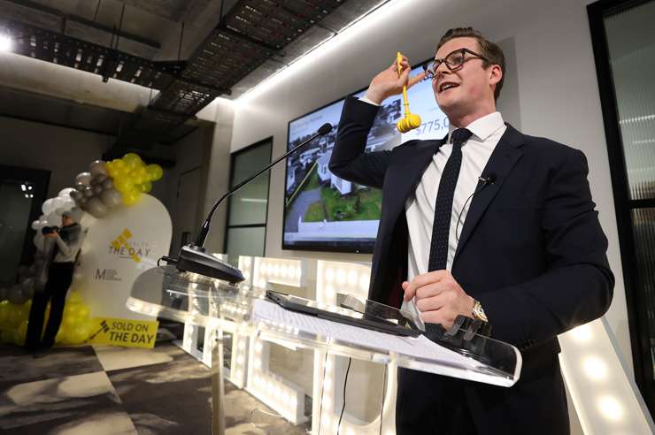 First-home buyers Sarah and Hayden Kingi in the thick of it at Ray White Manukau’s mega-auction on Wednesday. Photo / Fiona Goodall