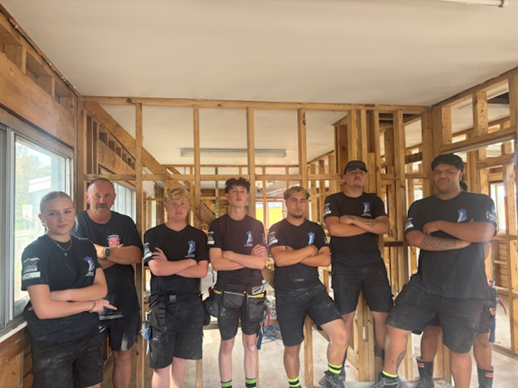 Eleven students from Trident High School, in Whakatāne, have spent the last eight months renovating an old smoko house. Pictured is tutor Hamish Galloway with some of the students. Photo / Boundless Vision and The Northern Group