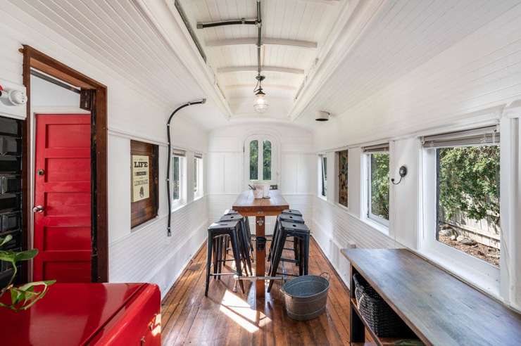 A three-bedroom home partially built from an old train carriage is on the market at 4 Driver Street, in Long Beach, Dunedin. Photo / Supplied