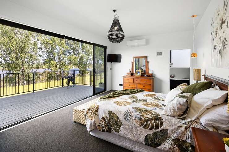 The five-bedroom, three-bathroom home on Ranby Road, in Ohaupo, was built using 12 steel shipping containers. Photo / Supplied