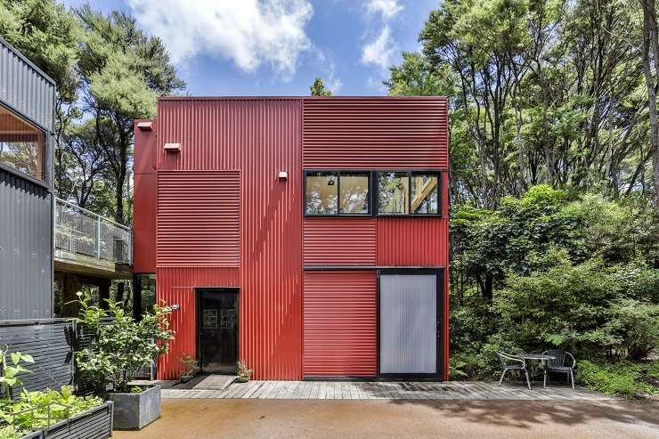 red corrogated iron house in bush 27 Longfellow Parade, Titirangi, Auckland