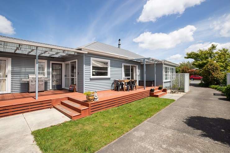 A three-bedroom bungalow on Hills Road, in Mairehau, had 11 offers presented within three weeks of going on the market. Photo / Supplied