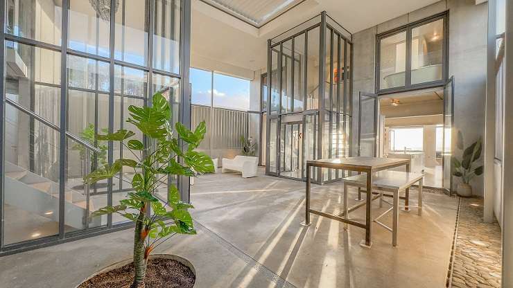 A concrete and glass beach home at Beverley Terrace, in Whangamatā, sold in December. It had a RV of $6.45m. Photo / Supplied