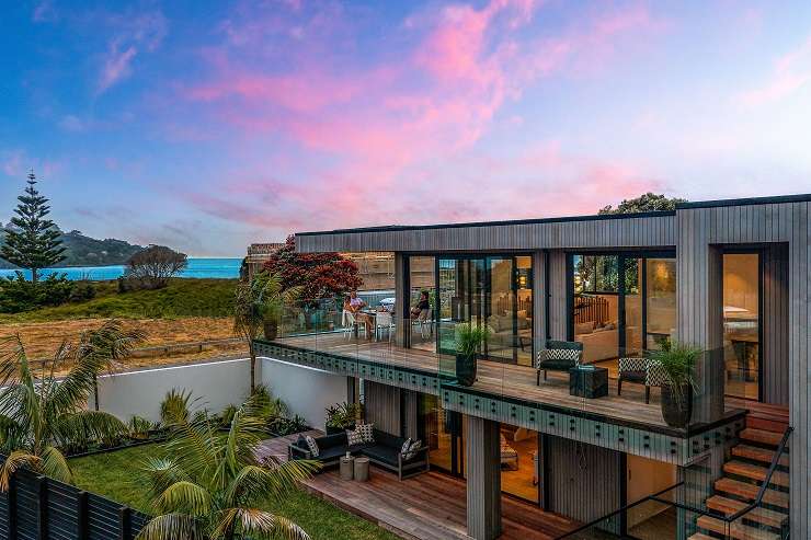 6 Kowhai Street Takapuna  A modern square cedar and concrete house with hedge and driveway in front