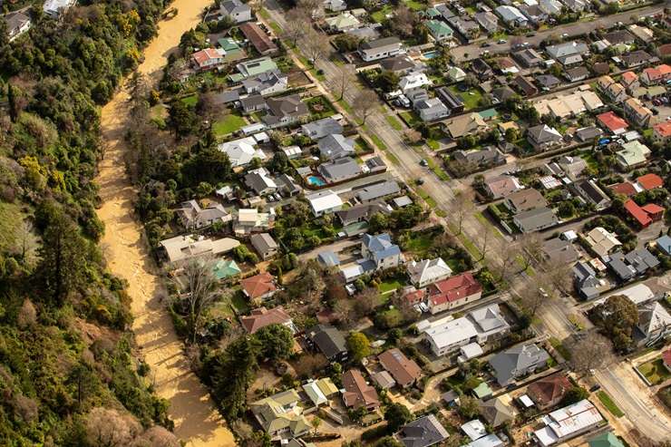 Flood-damaged furniture lies in the front yard of a house in the Motueka Valley. Photo / Tim Cuff