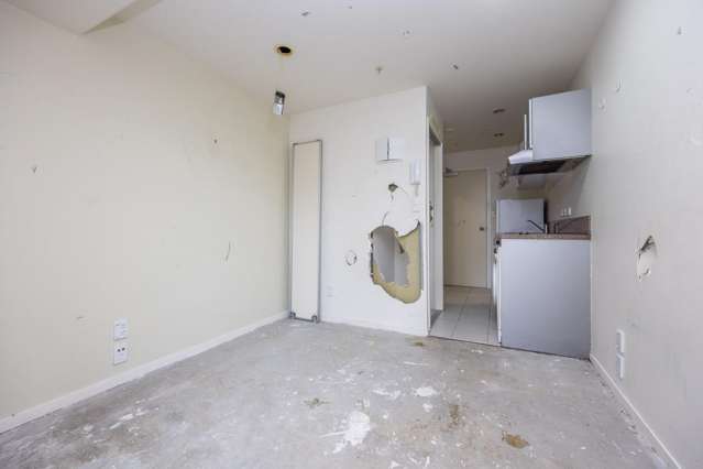 'Dirty, dusty, derelict': Destroyed Auckland CBD apartment sells for $43,200