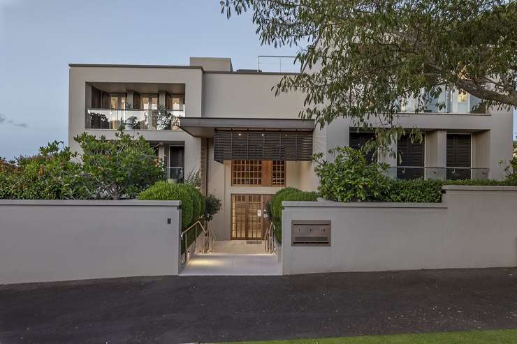 Grey villa with white picket fence and hedge at 23 Cheltenham Road, Devonport